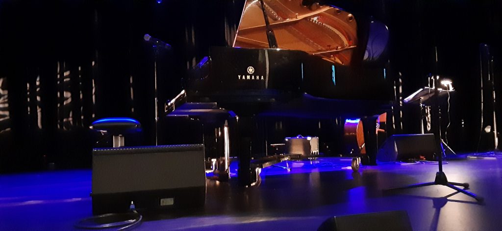 Image of a piano sitting on stage